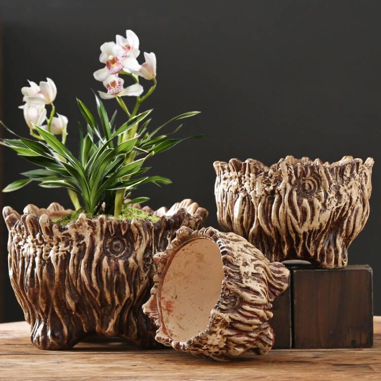 a group of ceramic pots with flowers