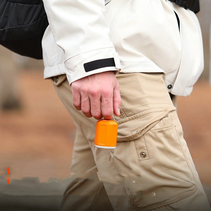 a person holding a can in their pocket