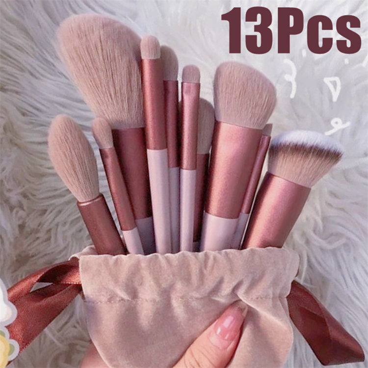 a hand holding a bag of makeup brushes