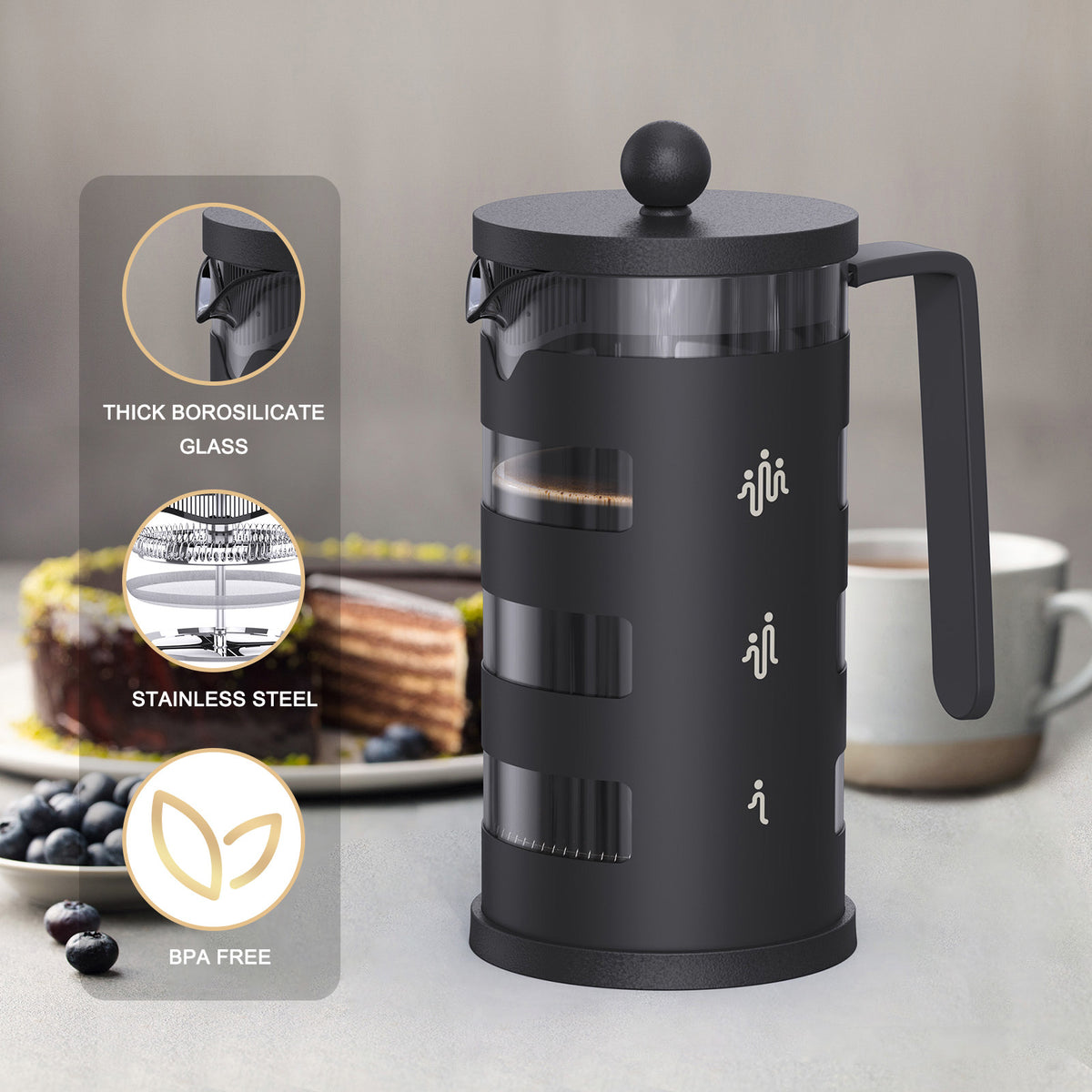 a black coffee maker with a handle and a cup of coffee