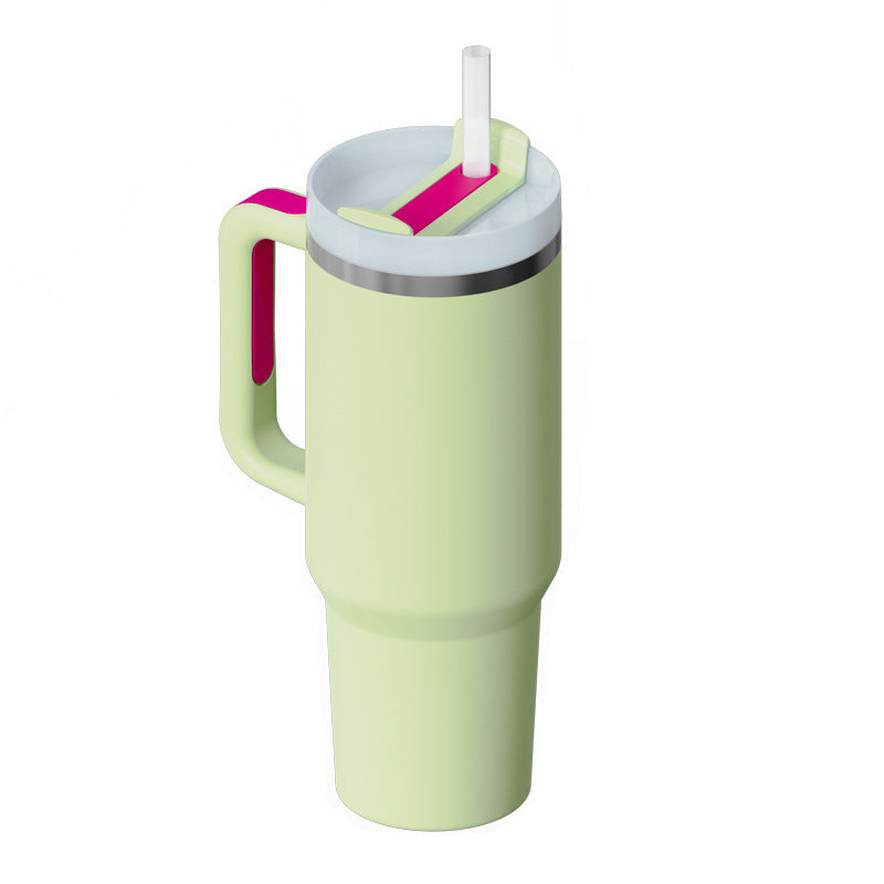 a green and pink tumbler with straw