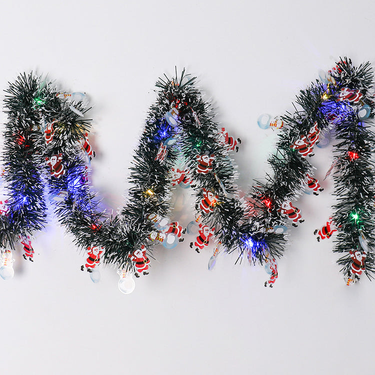a garland with lights and santa claus on it