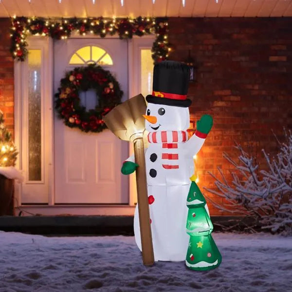 a snowman in front of a house