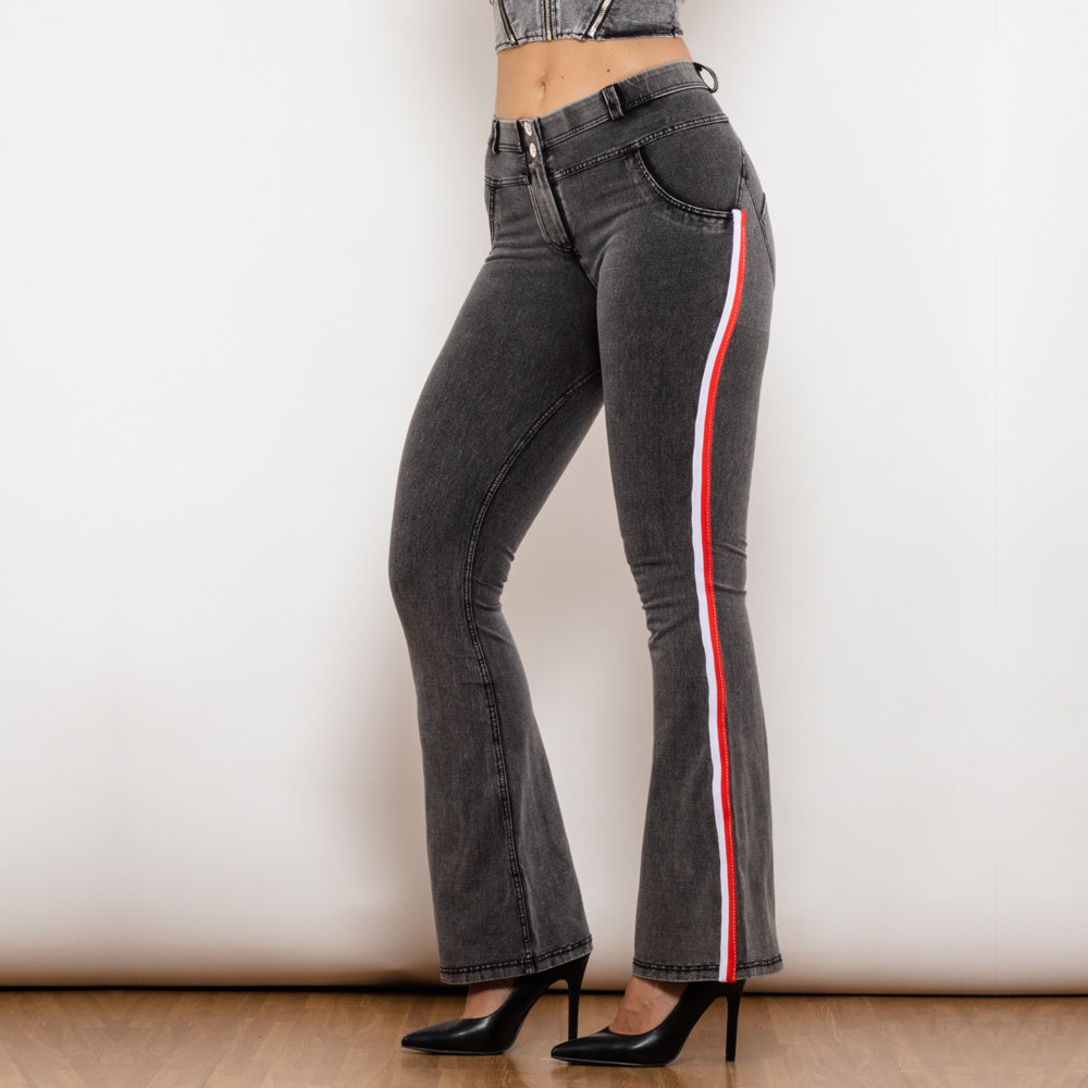 a woman wearing black jeans and black high heels