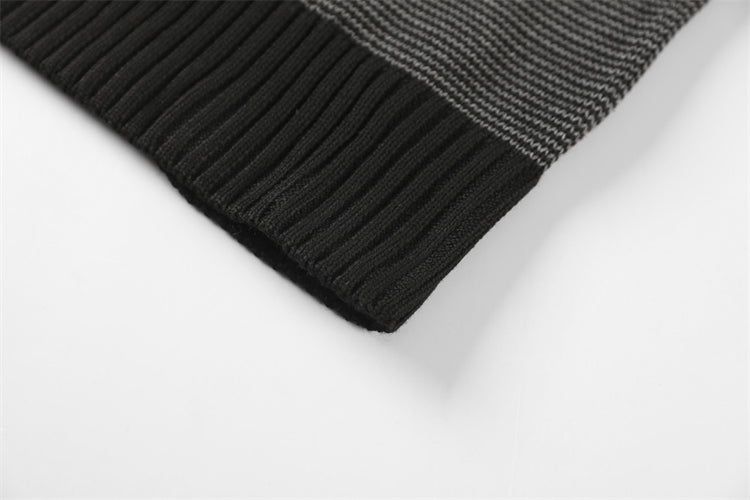 a close up of a black and white knitted hat