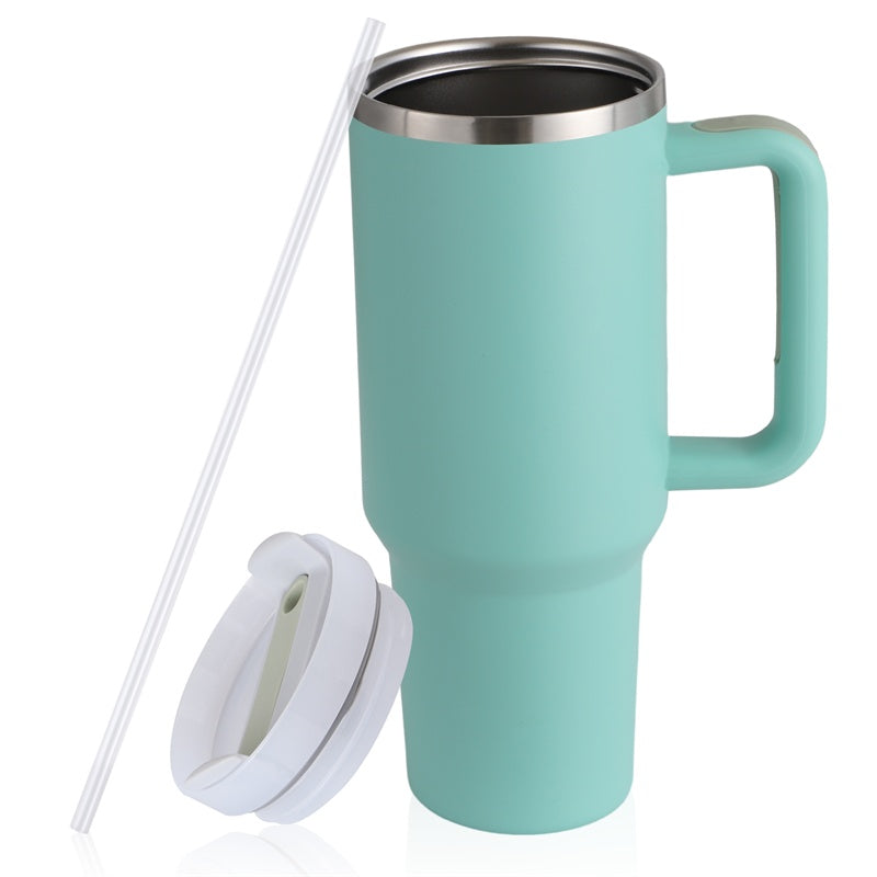 a teal and white coffee mug with a straw