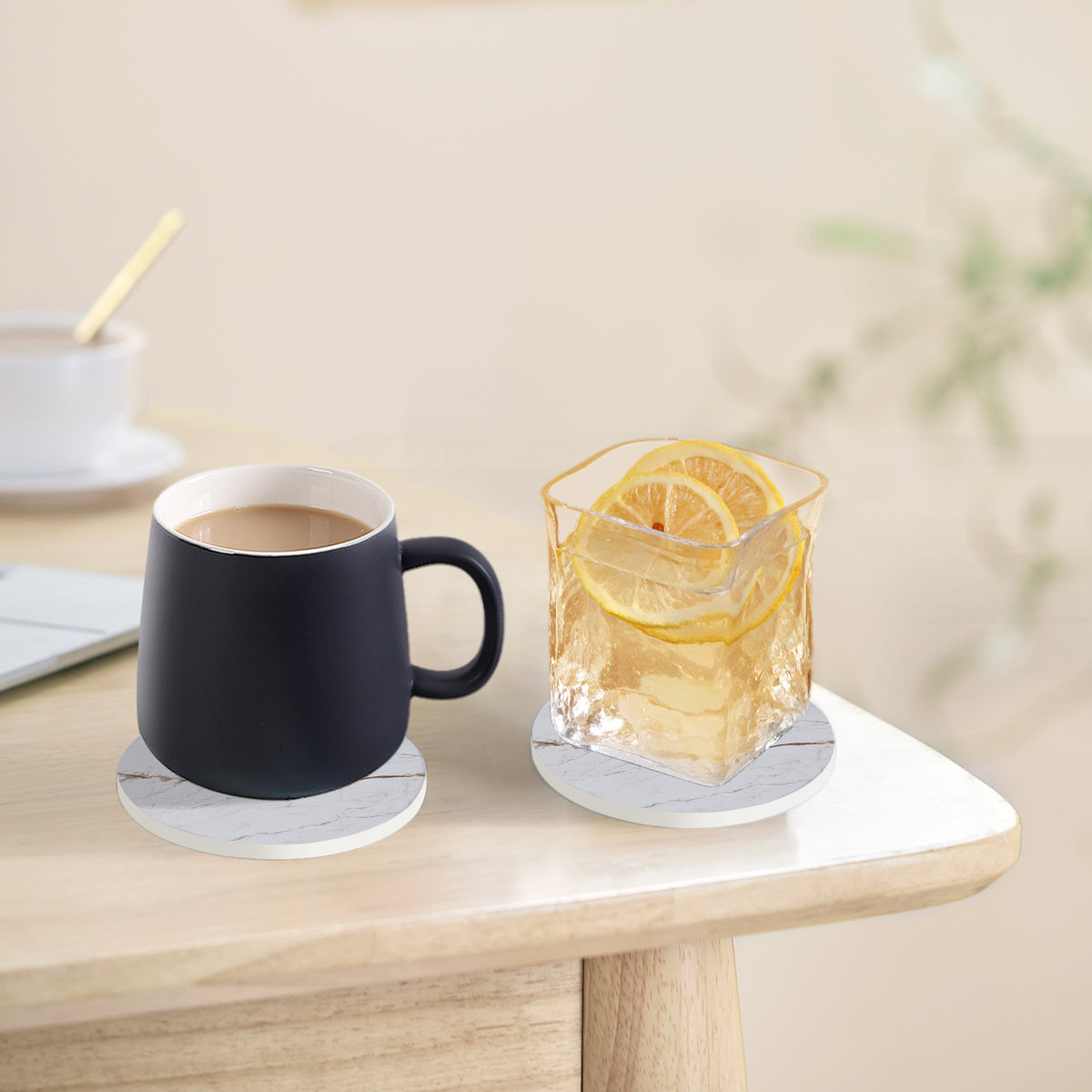 a cup of coffee and a glass of ice cube on a table