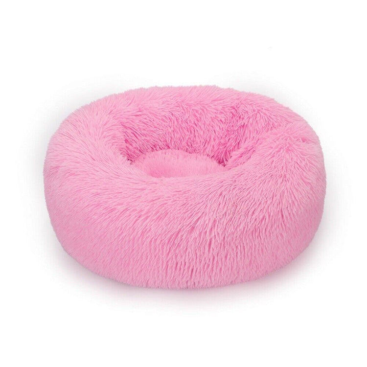 a pink furry dog bed