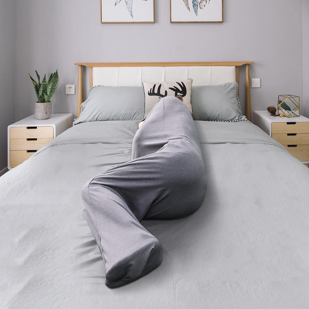 a person in a grey sheet on a bed