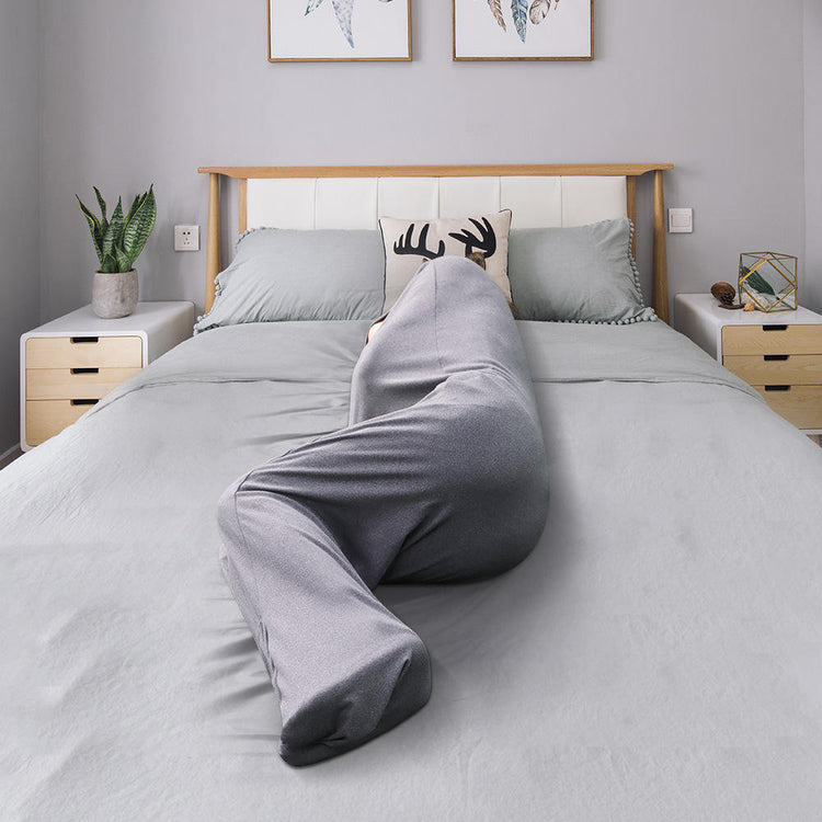 a person in a grey sheet on a bed