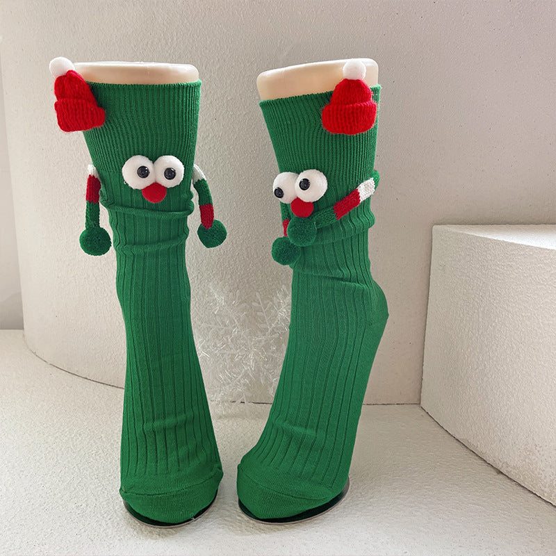 a pair of green socks with eyes and a hat