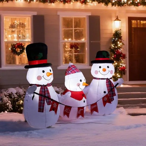 a group of inflatable snowmen in front of a house