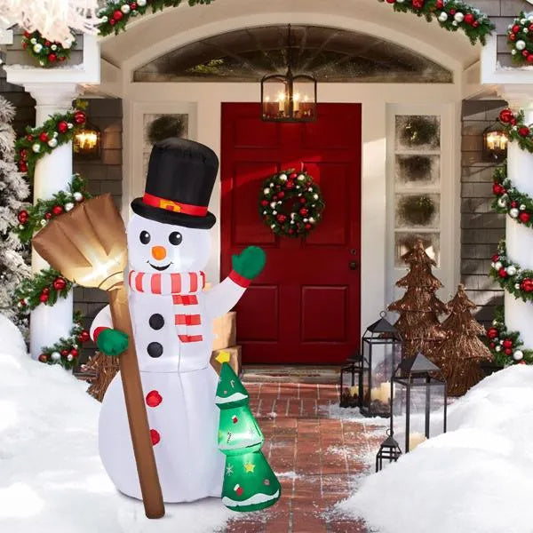 a snowman in front of a house