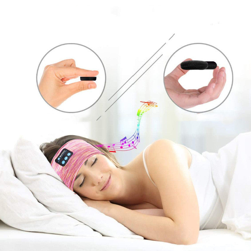 a woman sleeping in bed with a device