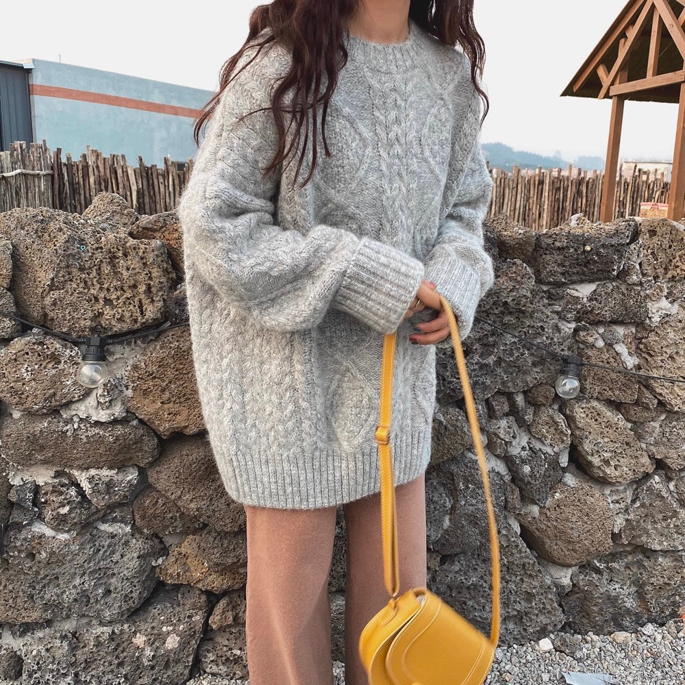 a woman wearing a sweater and holding a yellow purse