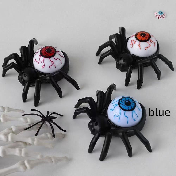 plastic spiders and bones on a white surface