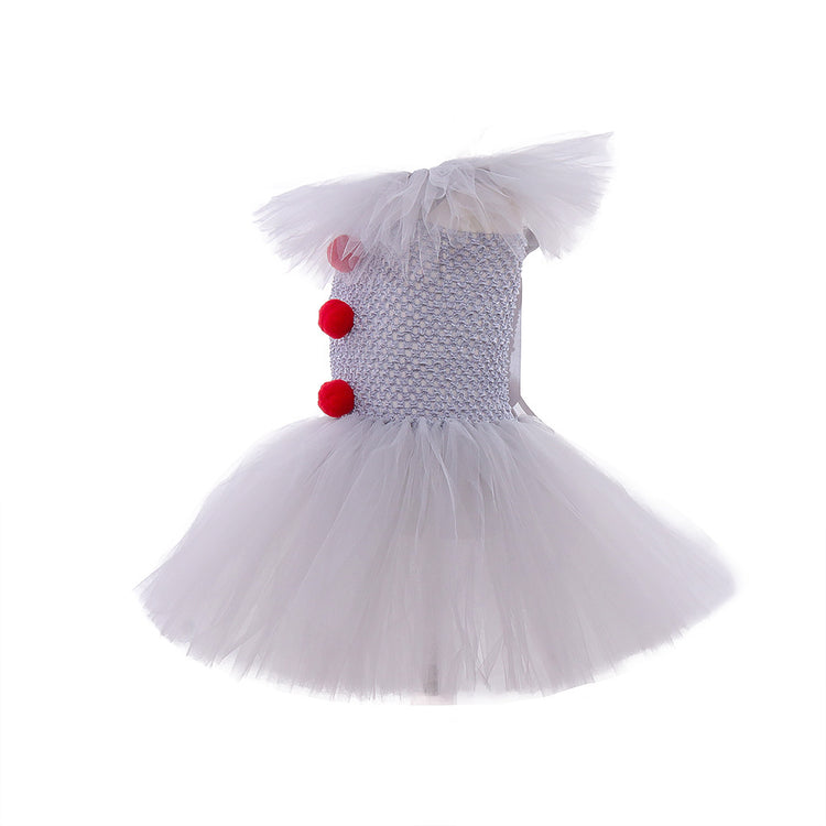 a white tutu with red pom poms