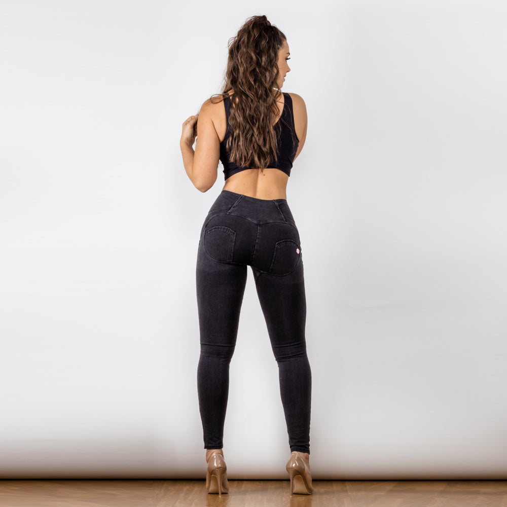 a woman in black jeans and a tank top