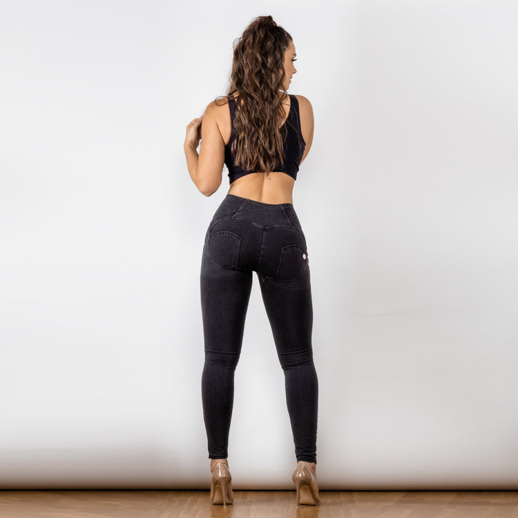 a woman in black jeans and a tank top