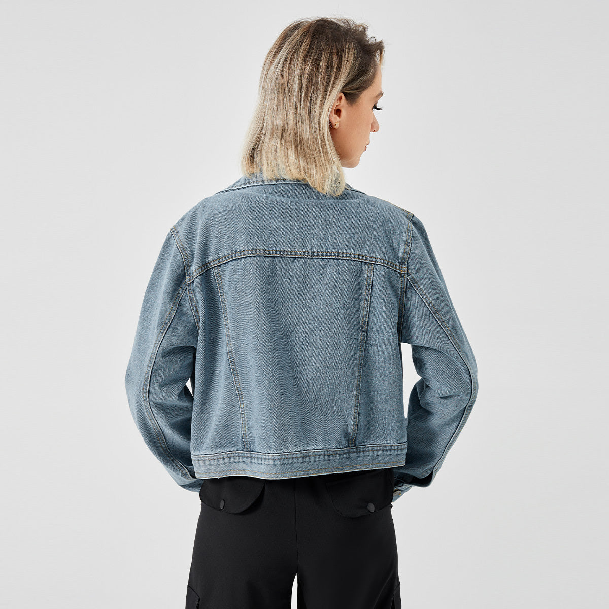 a woman in a denim jacket