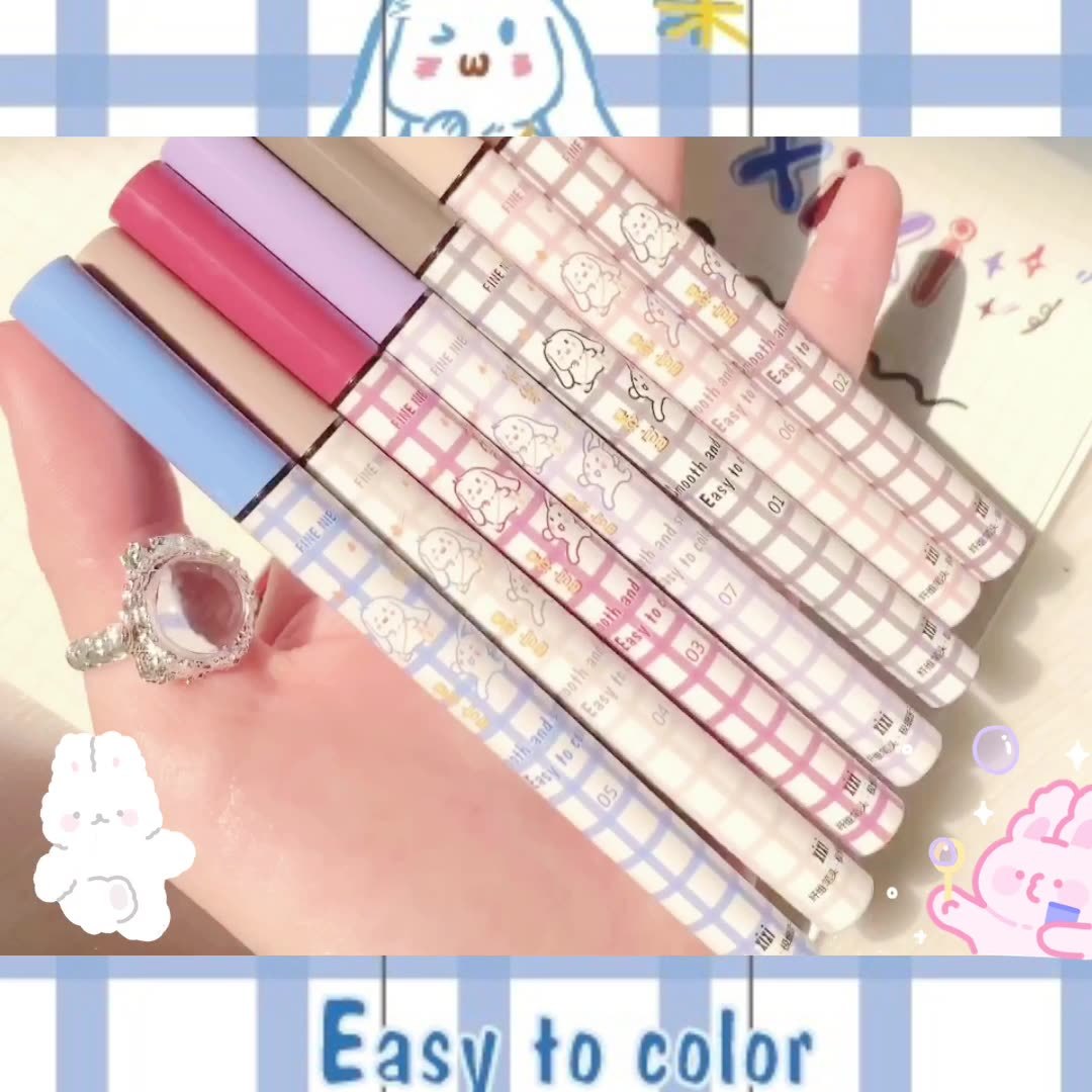 a hand holding a set of pens
