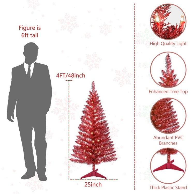 a man standing next to a christmas tree