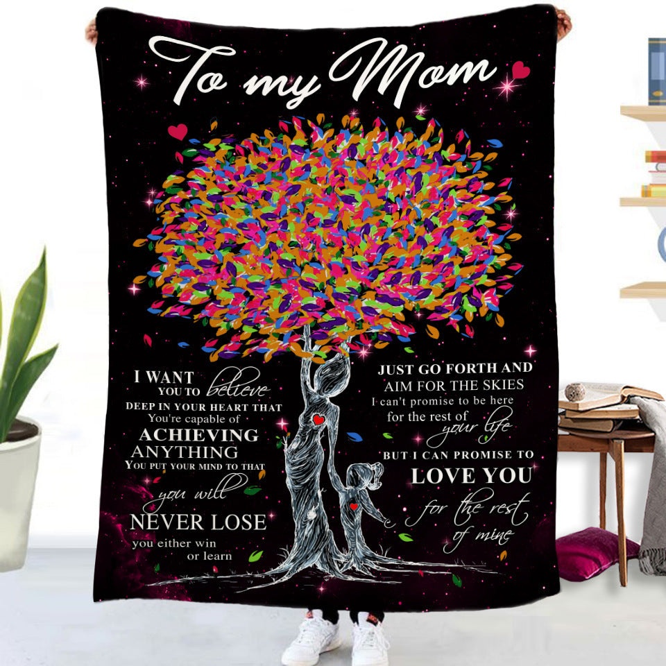 a blanket with a tree of leaves on it
