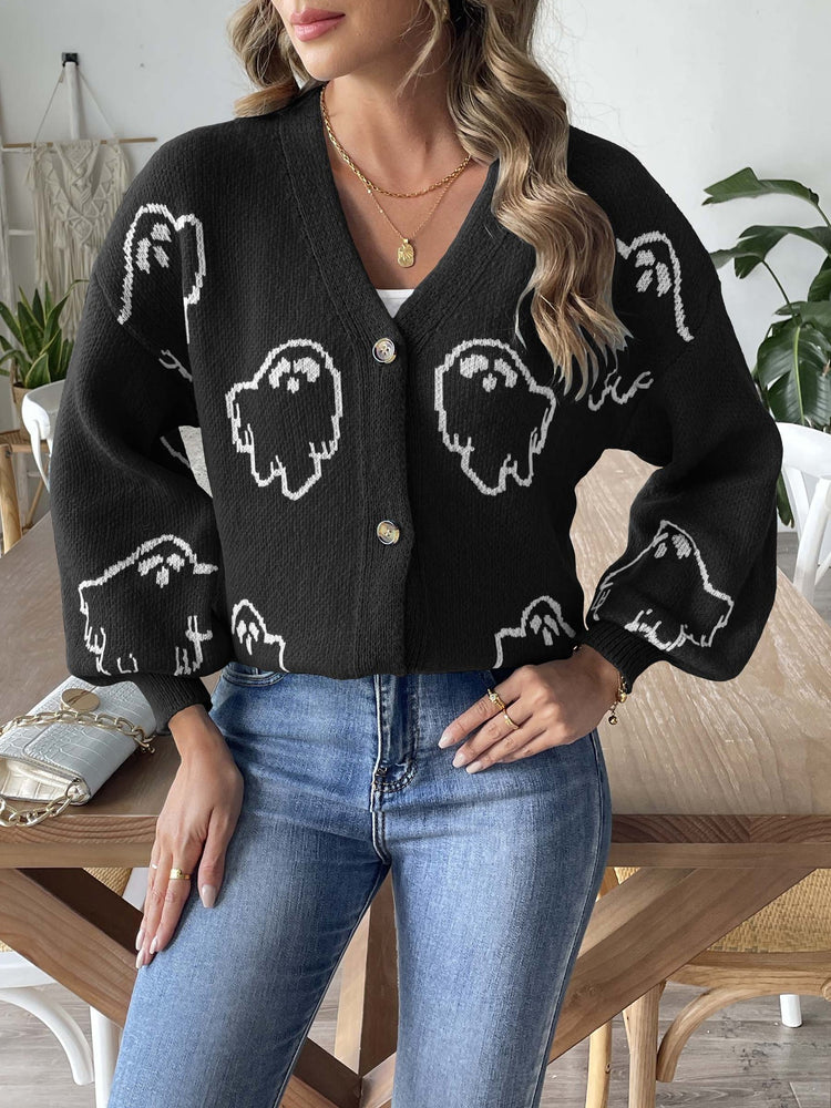 a woman wearing a black sweater with white ghosts on it