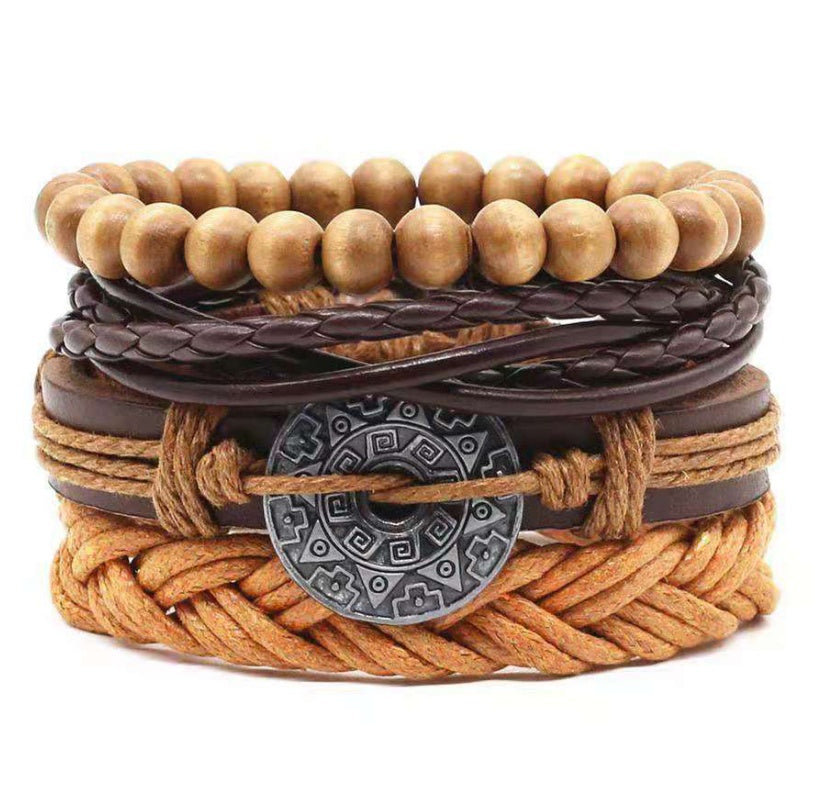 a stack of bracelets with beads and a metal disc
