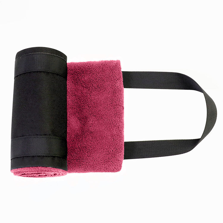 a pink towel rolled up on a white background