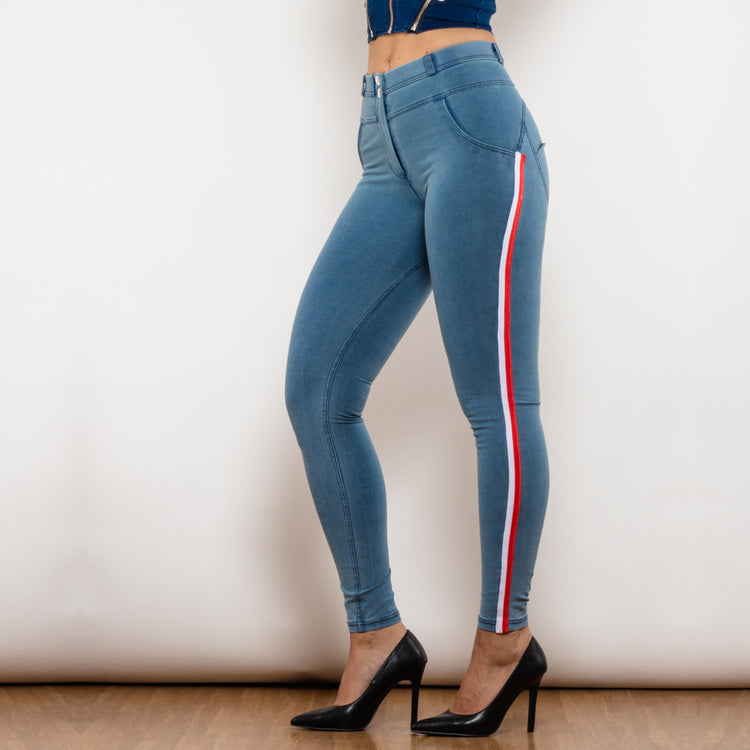 a woman wearing blue jeans and black heels