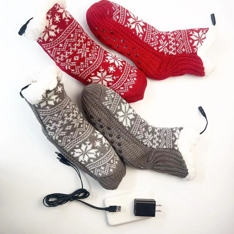 a pair of red and grey knitted socks with white and snowflakes