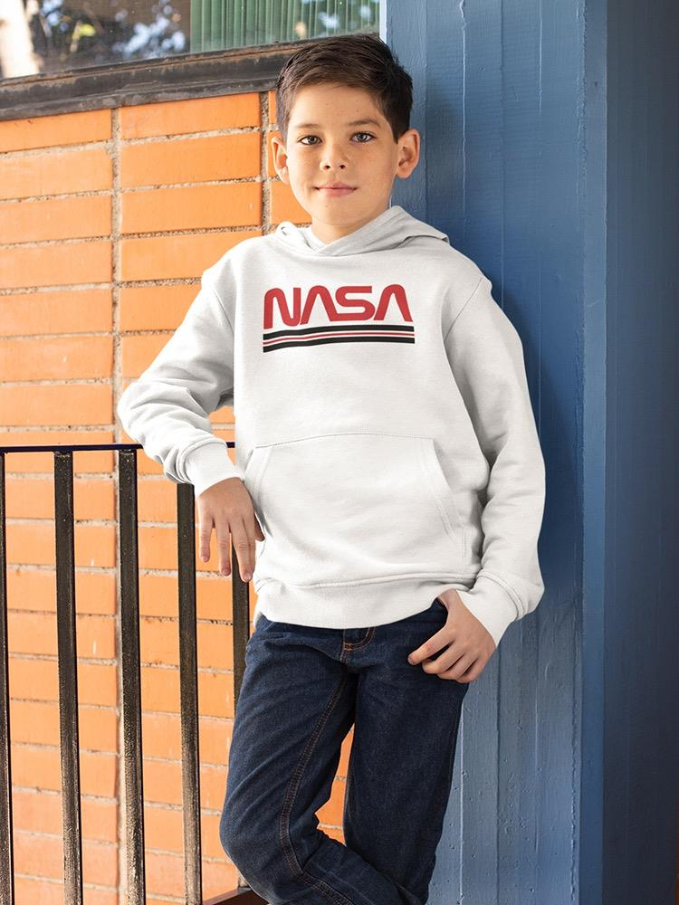 a boy standing next to a railing