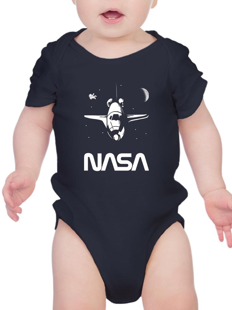 a baby wearing a black bodysuit with a white airplane on it