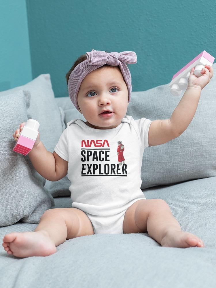 a baby with a purple headband holding a toy