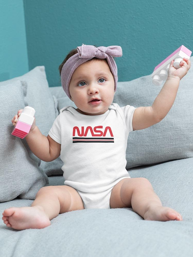 a baby with a purple headband holding a toy