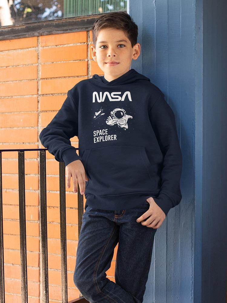 a boy standing next to a railing