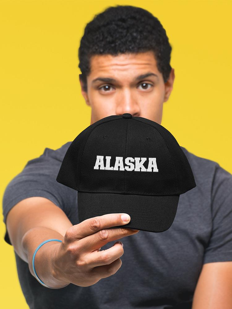 a man holding a black hat