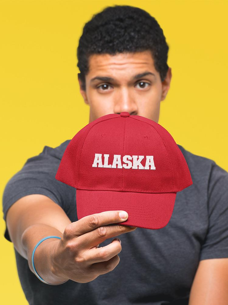 a man holding a red hat