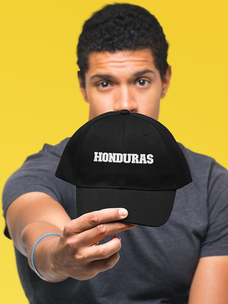 a man holding a black hat