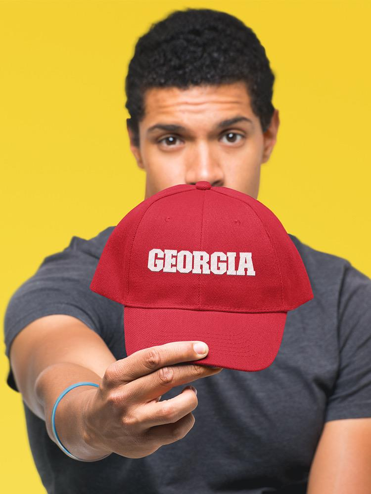 a man holding a red hat