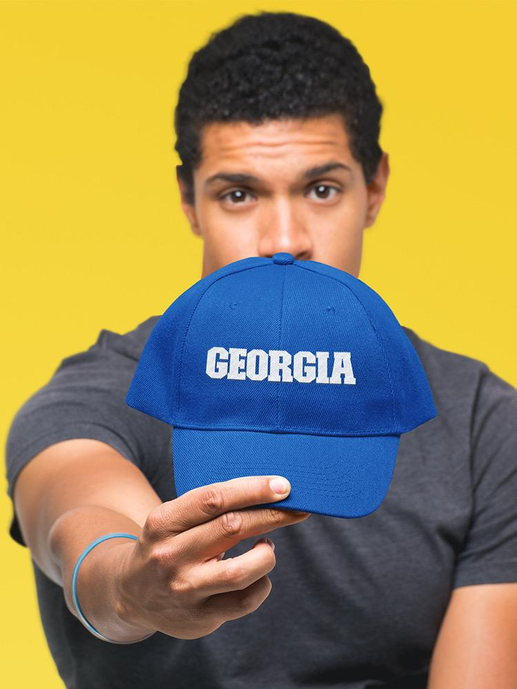 a man holding a blue hat