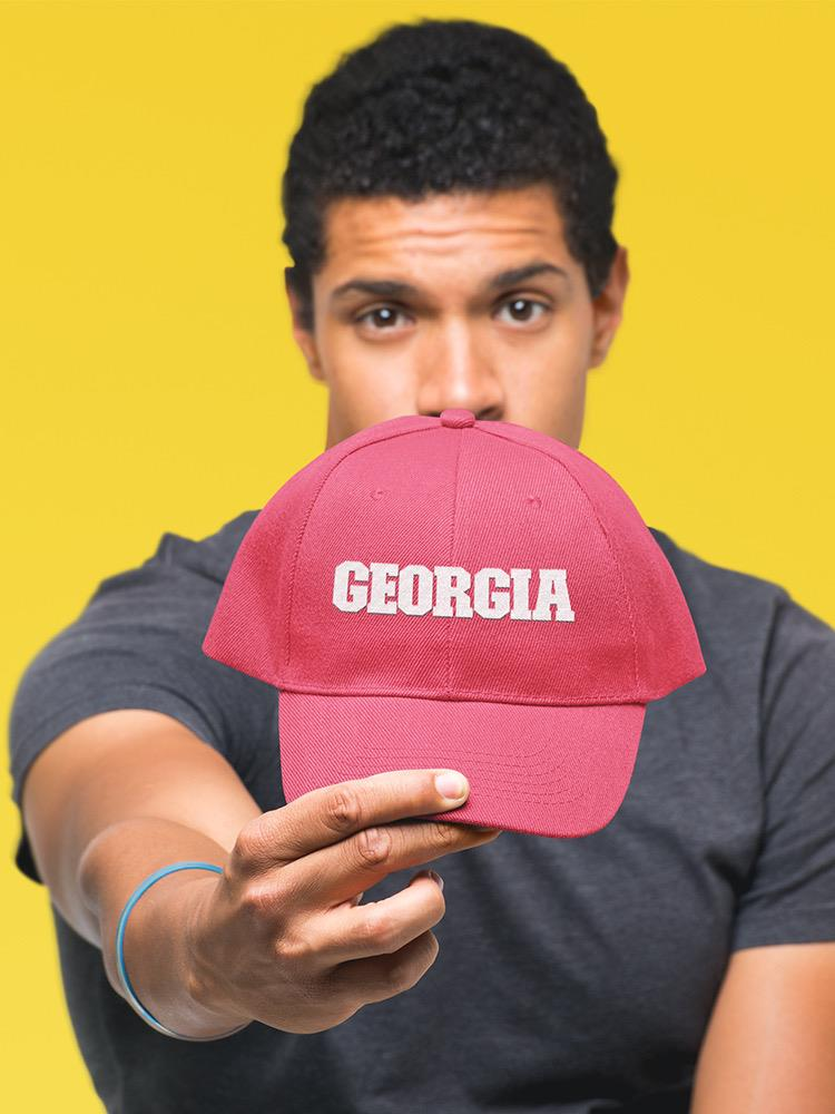 a man holding a hat
