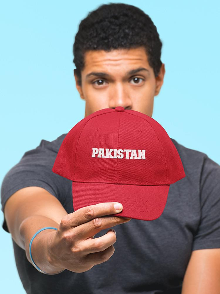a man holding a red hat