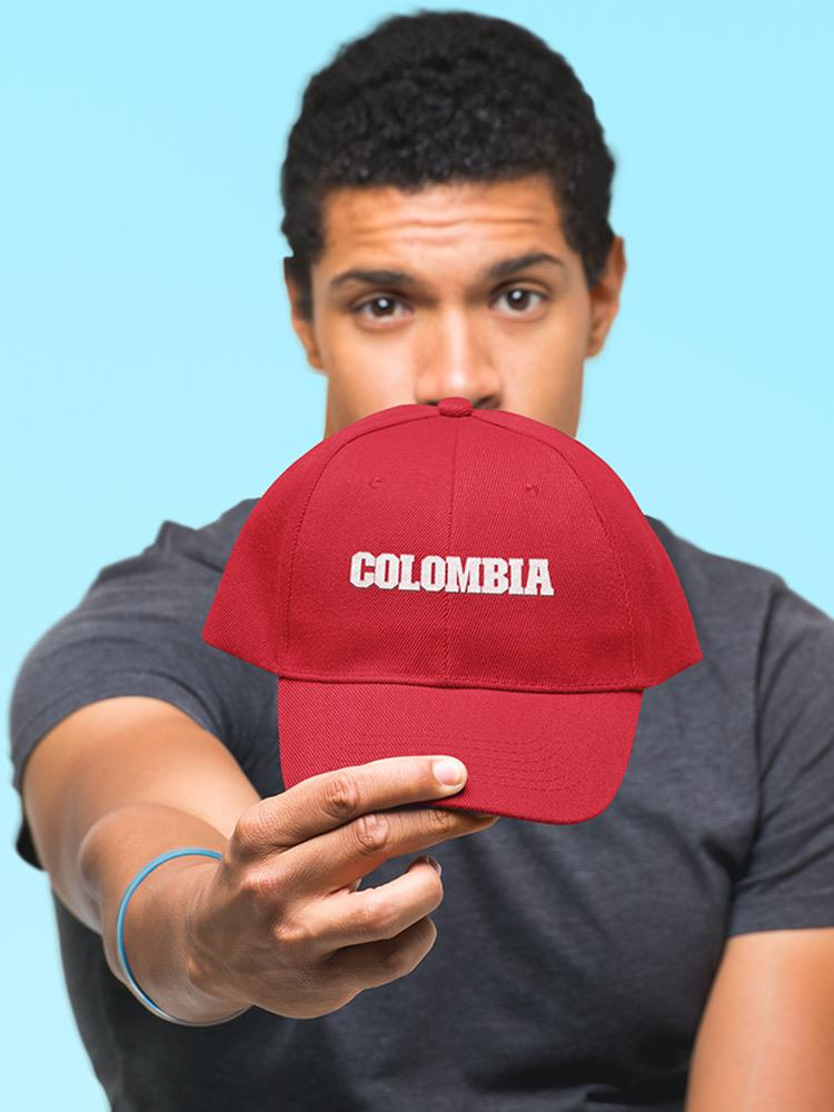 a man holding a red hat