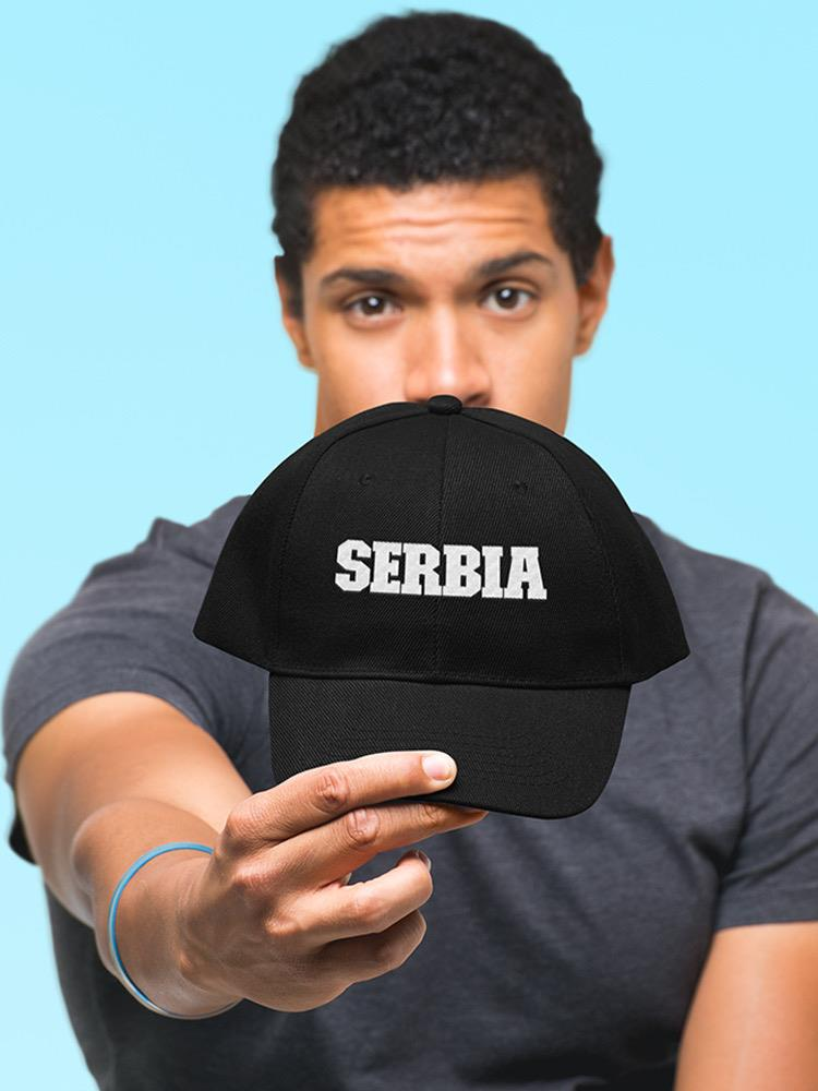 a man holding a black hat