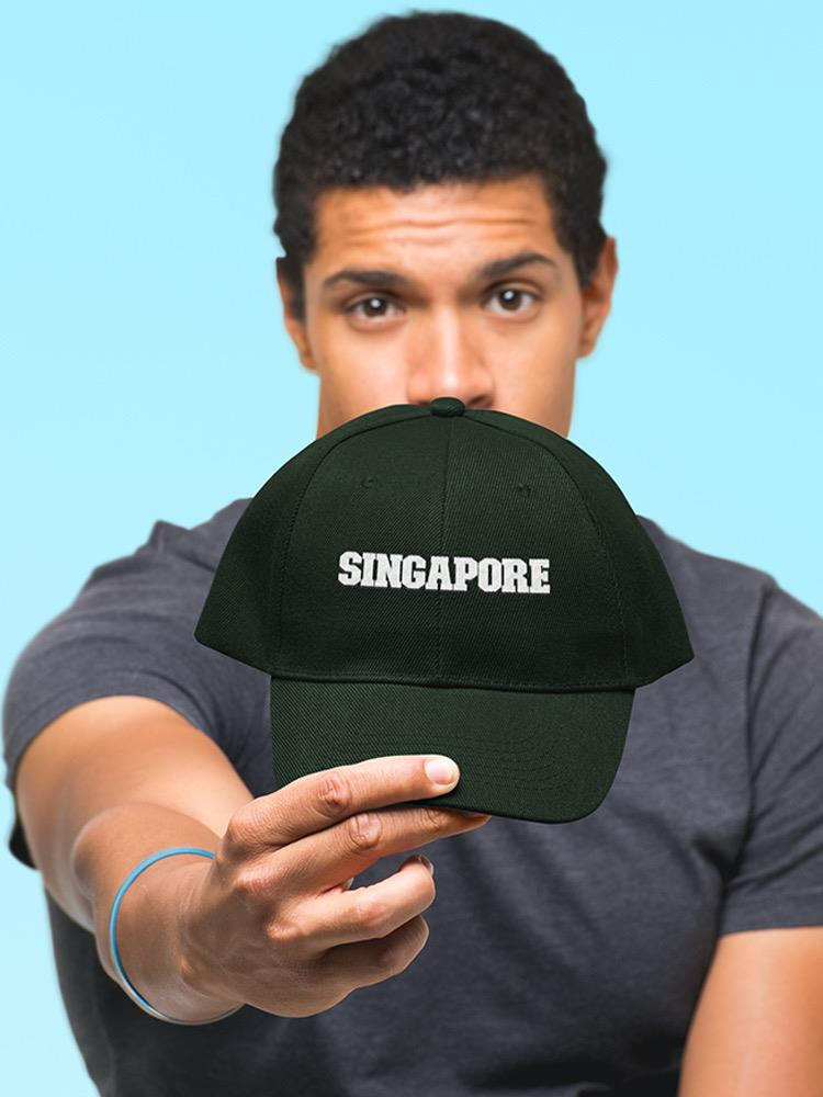a man holding a black hat