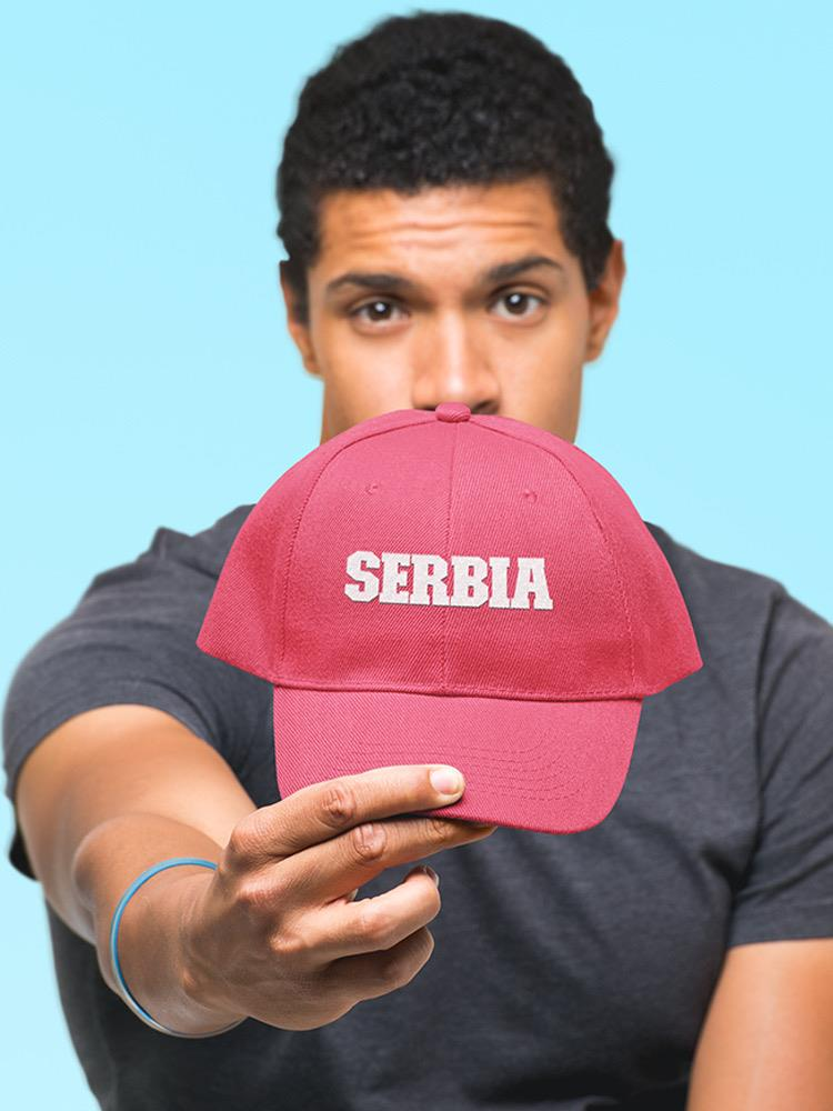 a man holding a red hat