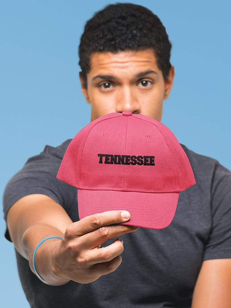 a man holding a red hat