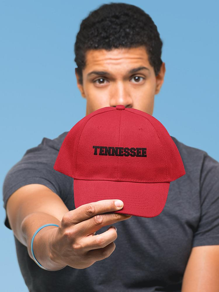 a man holding a red hat